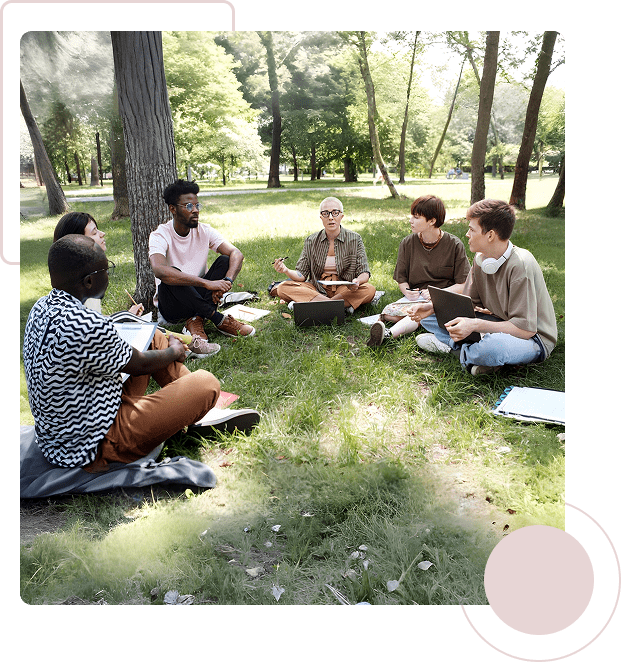 Young adults sitting on grass in a park, enjoying a group conversation.